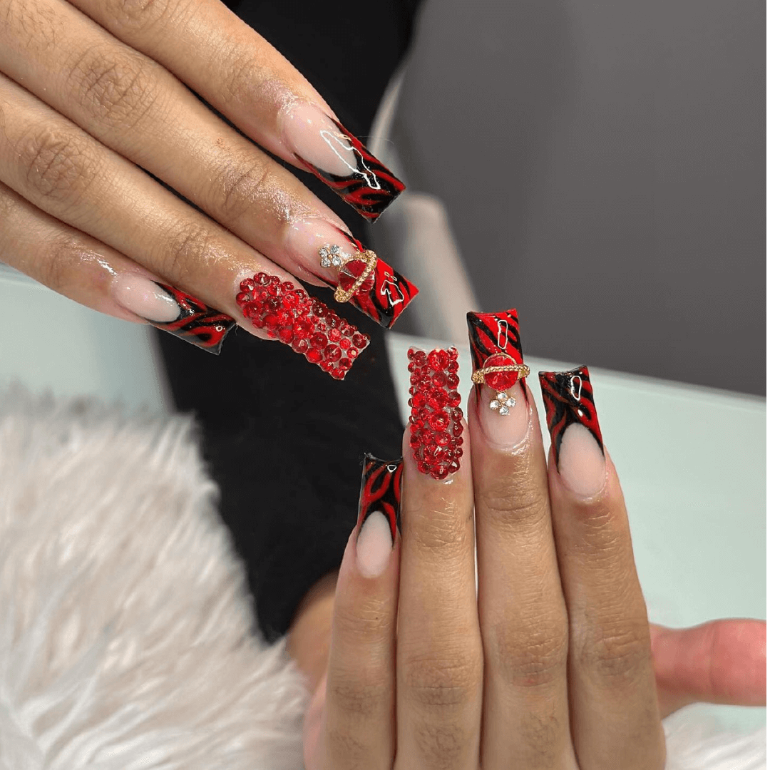 Red nails with embellishments